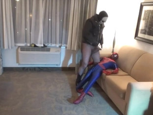 tattooed fishnet wearing guy humps his spiderman dummy